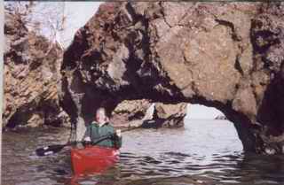 Kayaking beneath the Arch Rock